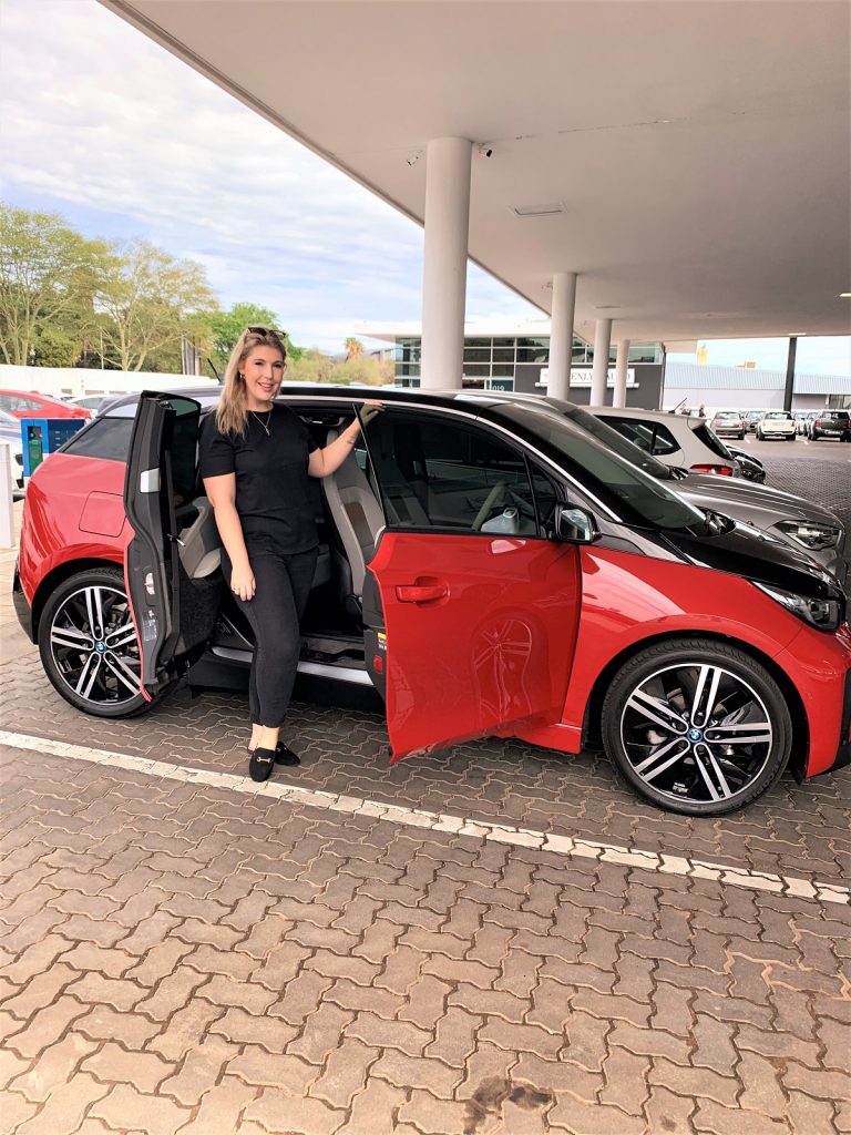 The Glam Green Girl with the BMW i3 that is being featured in her blog post. 